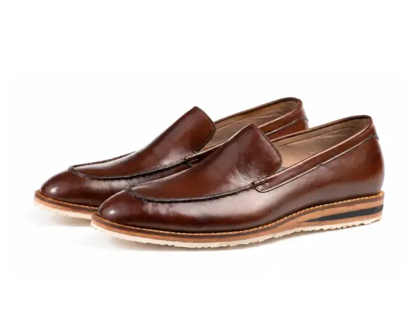 Pair of dark brown apron-toe loafers with cream Vibram soles and contrasting layered sidewalls