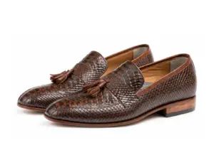 Pair of dark brown lizard-pattern tassel loafers with almond-shaped toes