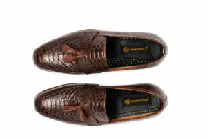 Top view of dark brown lizard-pattern tassel loafers showing tassels, apron stitching and Handsole insoles