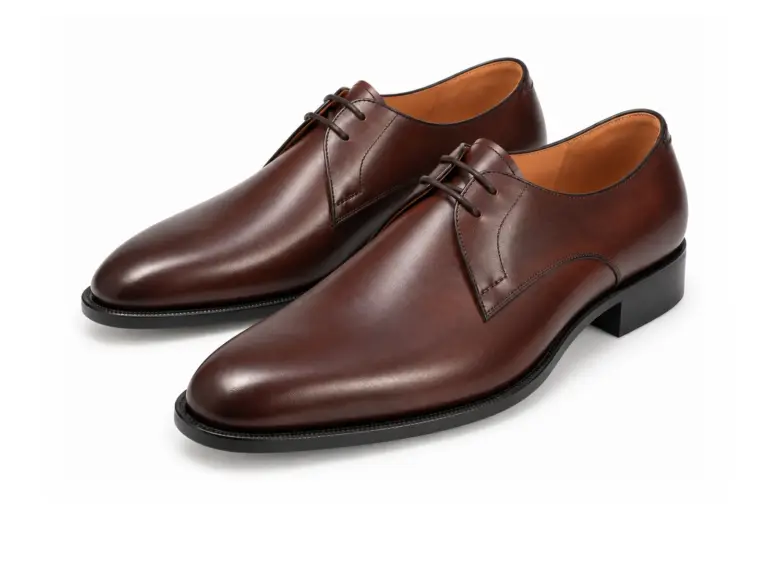 Dark brown two-eyelet plain-toe Derby shoes, left-facing three-quarter pair