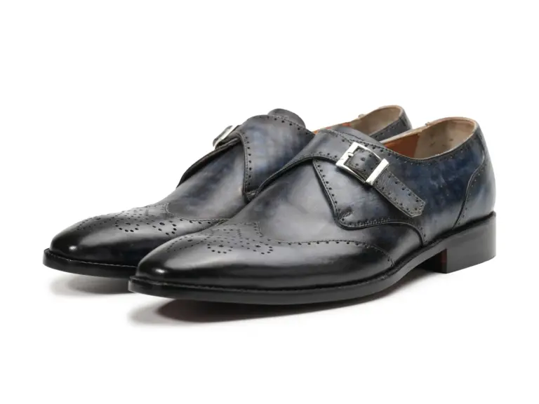 Pair of slate grey-black patina single monk strap shoes with wingtip toe and silver-tone buckle