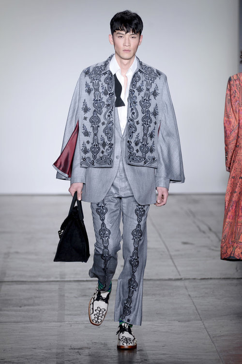 Model wearing Handsole black-and-white footwear with a grey patterned runway outfit