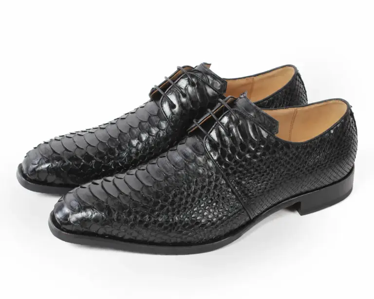 Three-quarter pair of men’s black Python leather Derby shoes with open lacing and low black heels