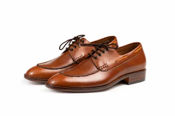 Pair of men's brown moc toe Derby shoes in pull-up leather