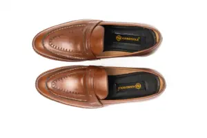 Overhead view of brown pull-up leather penny loafers showing the vamps and HANDSOLE-branded footbeds