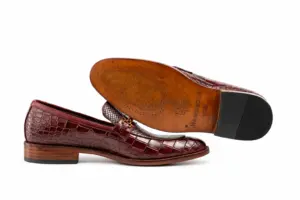 Leather outsole and dark heel top lift of burgundy reptile-pattern horsebit loafers