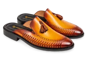 Pair of cognac burnished handwoven tassel mules with open heels and darker rounded toes
