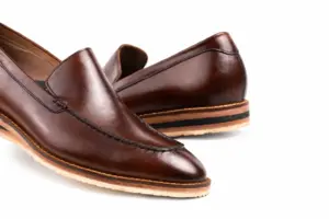 Close-up of the brown loafer apron stitching and cream outsole edge
