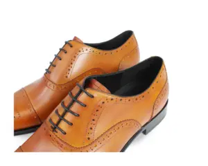 Men's tan leather semi-brogue cap-toe Oxford shoes, pair closeup view