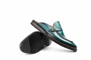 Crossed teal patina buckle mules with Vibram soles showing the upper, outsole and heel
