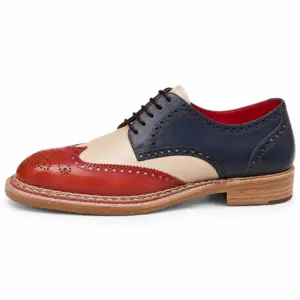 Men's tri-color wingtip Derby shoes in hand-painted navy, cream and red full-grain cow crust leather, side view showing the Norwegian welt
