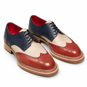 Pair of men's tri-color wingtip Derby shoes in hand-painted navy, cream and red cow crust leather, with red lining and dark waxed laces