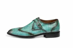 Outer side profile of turquoise patina wingtip single monk strap shoes showing the upper shape and sole edge