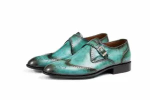 Pair of turquoise patina wingtip single monk strap shoes showing the forepart and sole profile