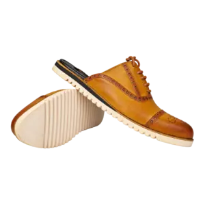 Mustard cognac brogue lace-up mules showing the upper and ridged outsole