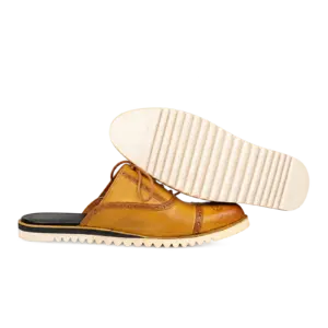 Cream ridged outsole beneath a mustard cognac lace-up mule