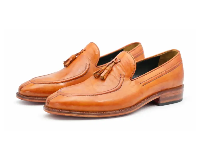 Tan apron toe tassel loafers, three-quarter pair view