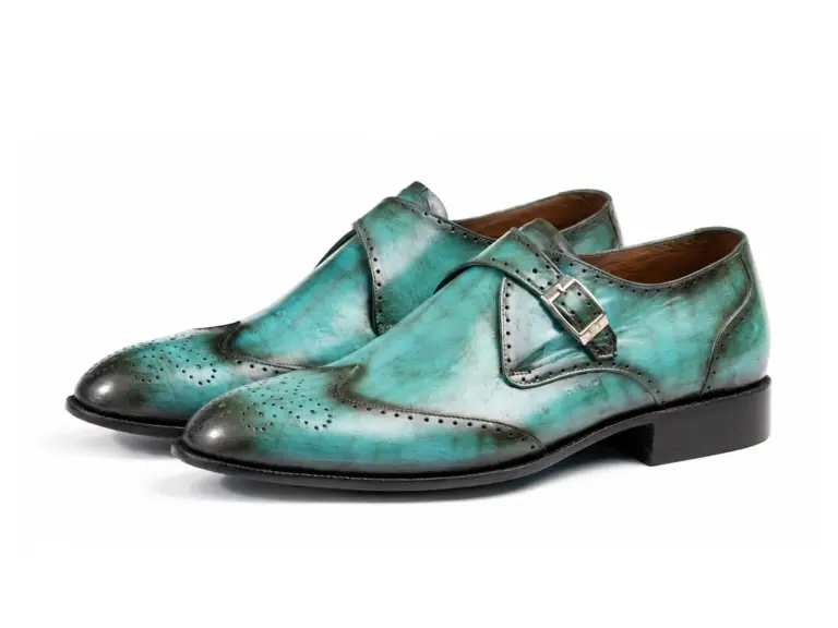 Pair of turquoise patina wingtip single monk strap shoes showing the forepart and sole profile